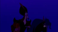 Jafar watching the scarab fly into a hill of sand.