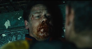 Peacemaker kills Flag, listening to the latter refer to him as a joke.