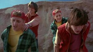 Evil Bill & Ted about to throw Bill and Ted off the cliff.