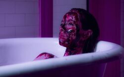 Ruby bathing in Jesse's blood.