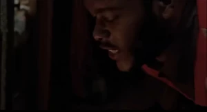 Isaiah struggling to force Joan’s head into the firepit.