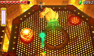 The Links battling Moldorm in the Fire Temple.