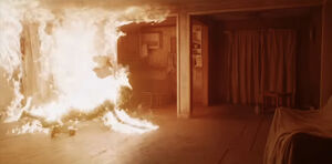 The Smile Entity pretending to burn, giving Rose a false sense of security.