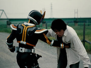 Saeko as Kaixa punching Masato Kusaka.