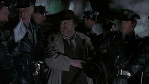 Eckhardt leading a team of officers to kill Napier under the orders of Carl Grissom.