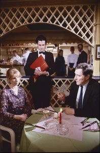 Alan taking Dawn out on a date under the pretense of discussing business expansion.