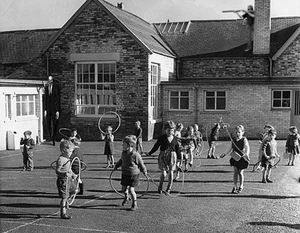 Slender Man standing on the roof of a school.