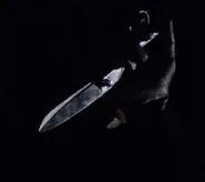 Martha raising her shears to kill her son