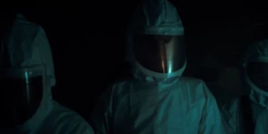 Brenner walking through the contaminated hallway.