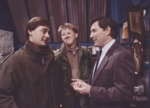 Alan feigns an apology to Terry in front of fellow neighbor Curly Watts.