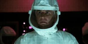 Brenner watching his colleagues attempting to save Shepard.