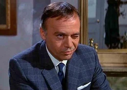 Inspector Dreyfus with his typical nervous eye twitch caused by Clouseau's mere presence.