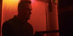 Grigori drawing out his gun after finding one of his fellow comrades dead.