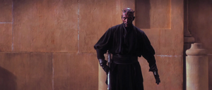 Darth Maul reaches for his lightsaber on his belt