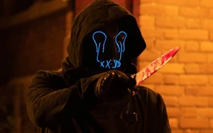 Wyatt raises a bloody knife threateningly at Frank.