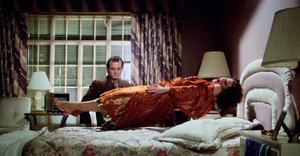 An angered Zuul levitates off her bed, snarling ferociously as a stunned Peter looks on.