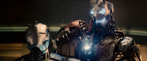 Ultron holding a deactivated Iron Legion before removing its mask.