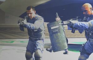 Becker ordering his men to kill Max while walking towards a flight of stairs.
