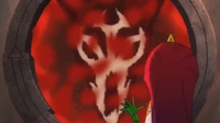 Necrafa's face reflects through the portal.