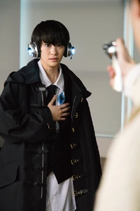 Naki having a gun pointed at her by Gai Amatsu.