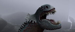Red Death roars in pain and anger as Snotlout whacks his hammer into the dragon monster's eyes