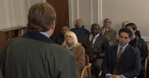 Phil rallies the community against Ian at the creditors meeting over Ian's bankruptcy (2000).