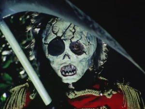 Major Skull holding up scythe.