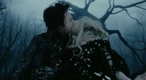 The Horseman biting Lady Van Tassel's lips, intending to make her pay for betraying him and making him commit the murders.