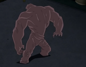 Clayface II's full appearance, but with his top half twisted around.