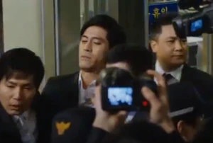 Kim arrested and escorted by authorities.