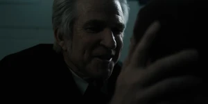 Brenner smiling at Eleven "El" when she wakes up.