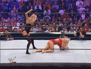 No Mercy 2001: Whipping Torrie as the referee tries to stop her