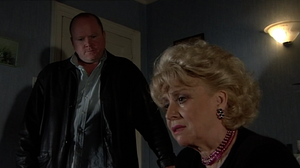 Phil comforts Peggy after they learn that Frank and Pat were having an affair behind her back for months (2000).