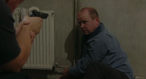 Phil wakes up to find himself held captive by Dan at gunpoint (2001).