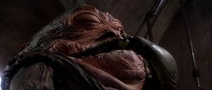 Jabba eating a paddy frog, satisfied of Oola's death.