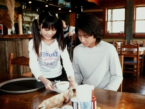 Hajime being served tea by Amane.