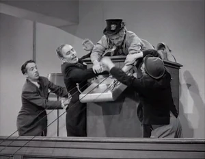 Grover and Duke fighting with Ravelli and Wacky over the picture