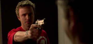 Jesse holding Gale at gunpoint.