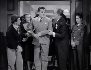 Grover, Joan Sutton, and Ravelli helping Tommy up