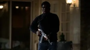 Little Paulie holding an assault rifle.