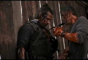 Hugo succumbing to his death after Rambo rips out his heart.