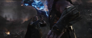 Thanos catches Thor's attack.