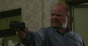 Phil threatens Dan with the latter's handgun (2001).