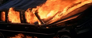 Dent's death.png (259 KB) Dent's car crashes down a slope and bursts into flames.