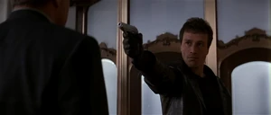 Korda threatening a man inside a jewelry store.