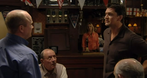 Phil confronts Dan for grassing him up to the police (2000).