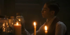 A young Henry looking at a spider trapped in a jar.