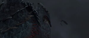 Hiccup and Toothless lead the Red Death into the dark clouds