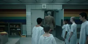 Brenner leaving the Rainbow Room with the children following him.
