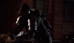 Saving a woman in his vigilante outfit.